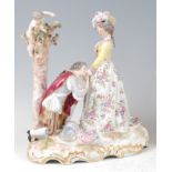 A late 19th century Dresden porcelain figure group , modelled as a kneeling gallant before his