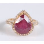 A yellow metal pear shaped ruby and diamond cluster ring, the ruby measuring approx 11.85 x 9.9 x