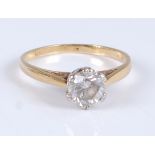 An 18ct yellow and white gold single stone diamond ring, the round brilliant cut diamond measuring