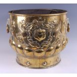 A 19th century continental brass log bin, with metal liner, the whole repousse decorated with
