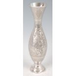 An early 20th century Persian white metal vase, of tulip shape, having all-over foliate engraved