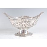 An Edwardian silver footed sweetmeat bowl, of pierced oval form, embossed with floral swags, 5.