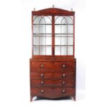 A Regency mahogany and inlaid secretaire bookcase, the upper section having twin astragal glazed