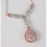 An 18ct white and rose gold fancy pear shaped diamond cluster necklet, featuring a pendant with a