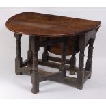 A circa 1700 joined oak dropleaf table, having oval fall leaves (with repairs), the base with ring