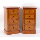 A pair of antique satinwood four drawer bedside chests, Victorian and later adapted, each having