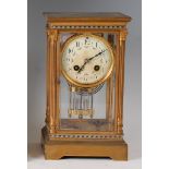 A circa 1900 French lacquered brass cased four glass mantel clock, the white enamel dial (badly