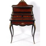 A 19th century French walnut and ebonised bonheur de jour, having a raised superstructure with