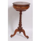A Victorian figured walnut pedestal teapoy, the hinged cover opening to reveal well-fitted