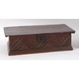 A Commonwealth period carved oak Bible box, of rectangular form, the hinged lid with iron strap
