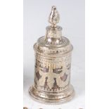 A circa 1900 continental white metal jar and cover, of cylindrical form, the cover with flaming