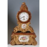 A late 19th century continental gilt composition mantel clock on integral stand, the clock of
