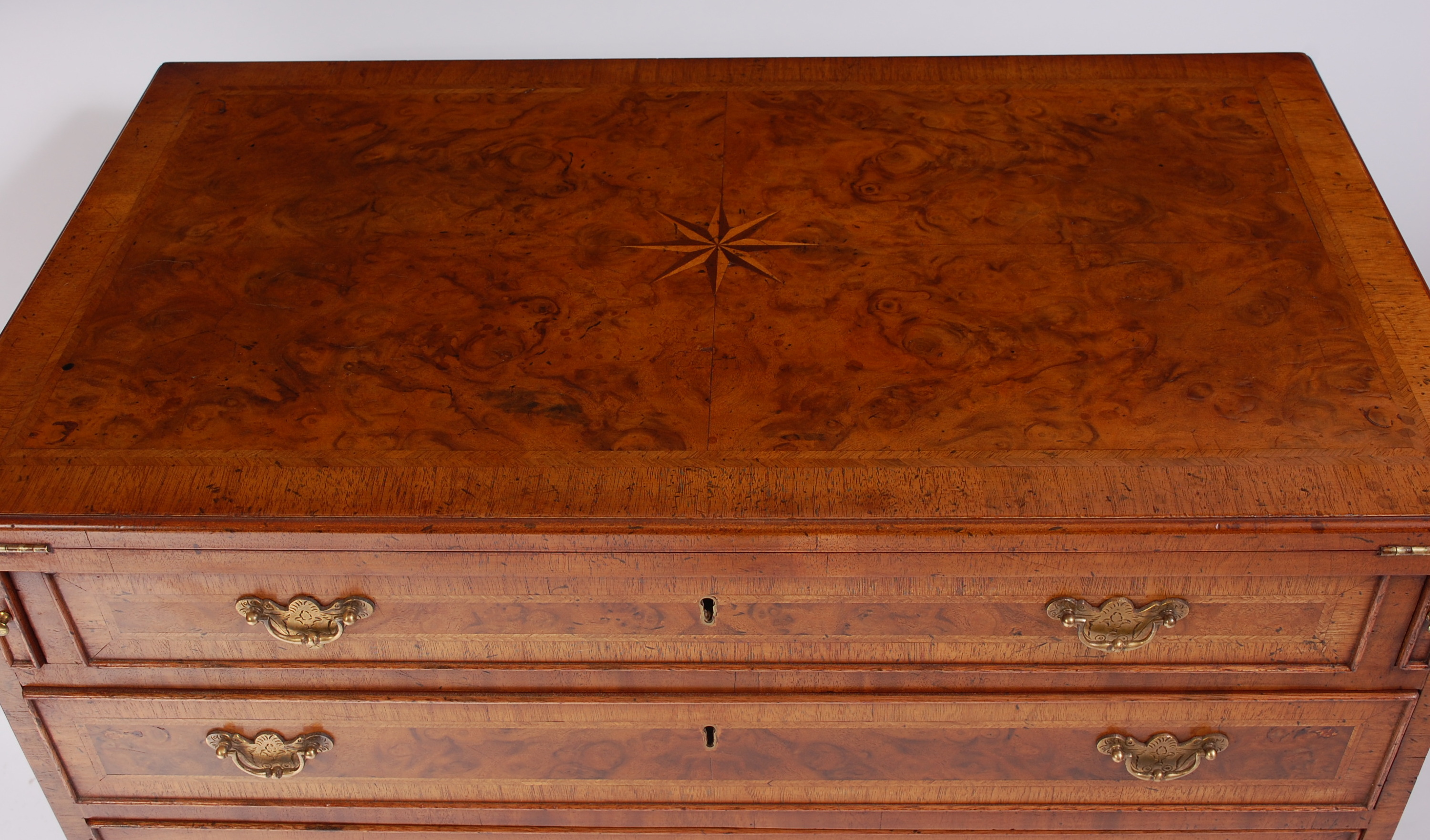 A figured walnut feather and crossbanded bachelors chest, in the George II style, the fold-over - Image 2 of 2