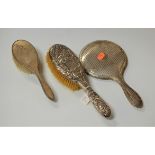 An engine turned silver backed hand mirror together with two silver backed hair brushes (3)
