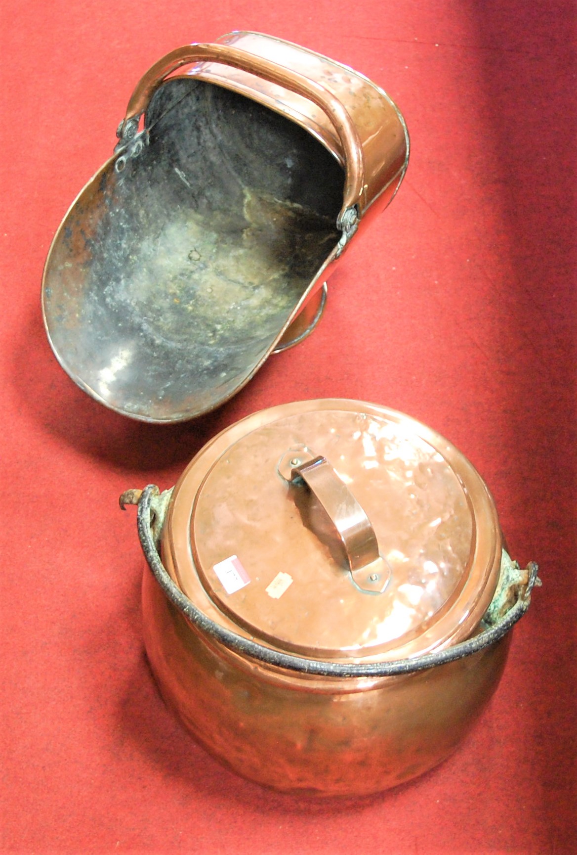 A copper cauldron with cover, together with a Victorian copper helmet scuttle (2)