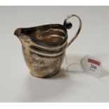 A 19th century white metal cream jug of helmet form being apparently unmarked, 3.2oz, height 10cm