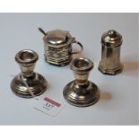 A pair of modern dwarf silver table candlesticks, each on loaded base; together with an early 20th