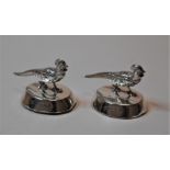 A pair of George V silver table place setting holders, each surmounted by a bird (2)