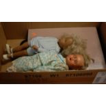 A box containing two modern dolls