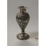 An Indian white metal baluster shaped vase, decorated with foliage, on a circular foot, h.16cm, 5.
