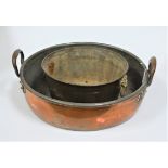 A copper twin handled preserve pan, dia. 40cm, together with a smaller twin ring handled brass
