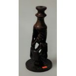 A carved softwood candle-holder, h.31.5cm