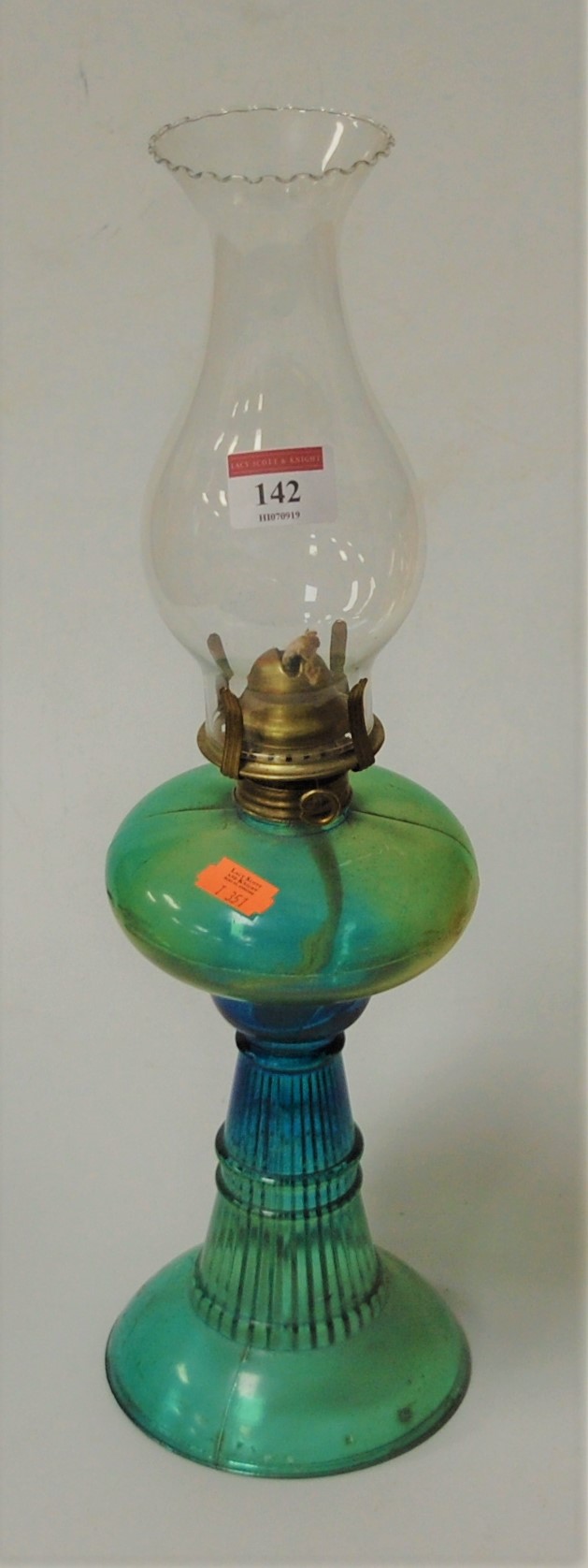 A moulded green glass pedestal oil lamp