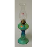 A moulded green glass pedestal oil lamp