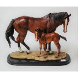 A contemporary moulded composition horse and foal group