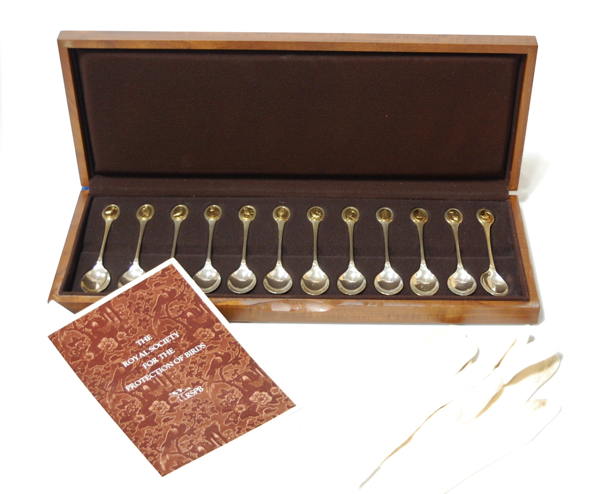 A cased set of 12 silver commemorative teaspoons as issued for the RSPB by Mappin & Webb