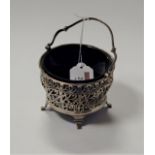 An early 20th century pierced silver sugar basket, with blue glass liner, London 1914, 4 oz (without