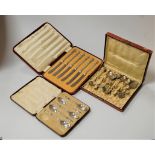A cased set of five silver apostle tea spoons, a cased set of 6 silver handled butter knives,