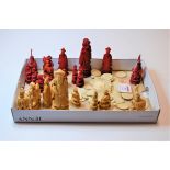 A collection of carved and stained chess pieces; together with various gaming counters