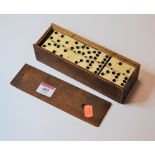 A set of early 20th century ebony and bone dominoes, boxed