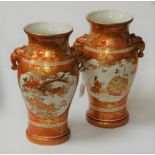 A pair of circa 1900 Japanese kutani porcelain vases, each decorated with figure and floral reserves