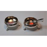 A matched pair of silver open salts in the George III style, each of squat circular form on pad