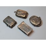 An Edwardian silver vesta, of waisted rectangular form, having foliate engraved decoration and