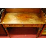 An early 19th century mahogany three-quarter ledgeback wash stand, having three frieze drawers and