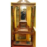 An Edwardian walnut mirrorback hallstand, having hinged central compartment and twin integral