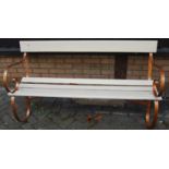 A cream painted slatted wood and wrought iron ended three-seater garden bench, w.149cm