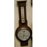 A 1930s oak aneroid two dial wheel barometer