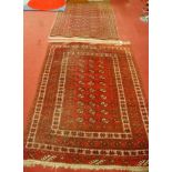 A Persian red ground woollen Bokhara rug, within multiple trailing borders, 188 x 140cm; together