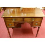 A 19th century mahogany kneehole four drawer side table, raised on turned and tapering supports,