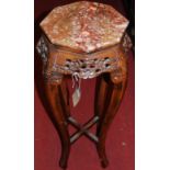 A Chinese, stained carved and pierced softwood octagonal marble top plant stand, height 90cm