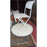 A contemporary white painted circular folding garden occasional table, together with a set of six