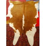 A large contemporary cow-hide rug