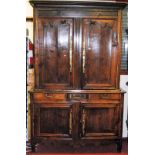 A 19th century provincial French oak buffet deux-corps, having twin upper and lower panelled