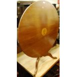 A reproduction mahogany circular pedestal low tilt-top tripod occasional table, dia. 75cm
