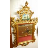 A Georgian style giltwood rectangular wall mirror, having a pronounced pierced floral decorated