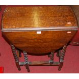 A small early 20th century barley twist turned oak drop flap occasional table